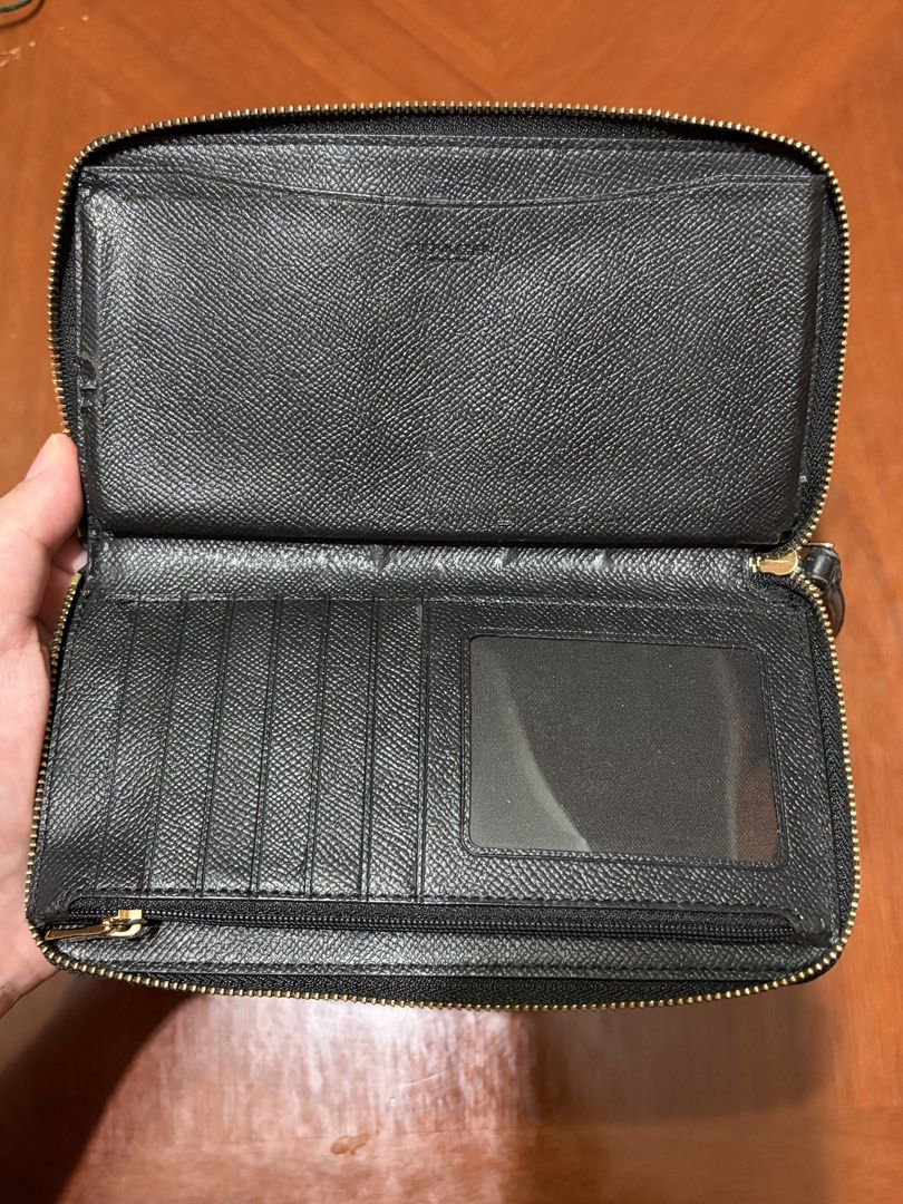 Coach Black Leather Zip Wallet (Category: Wallets & Card holders) located in Paranaque City. Submitted by clothesonlinemnl (Listing ID 1470647888, Image 3). Description: - Brand: Coach - Leather wallet - Design: Embossed horse and carriage logo - Zip-around closure with attached wrist strap - Exterior has no flaws at all, looks new - Interior WITH FLAW (seems due to storage) — see photos. Fully functional multiple card slots, ID window, slip pock
