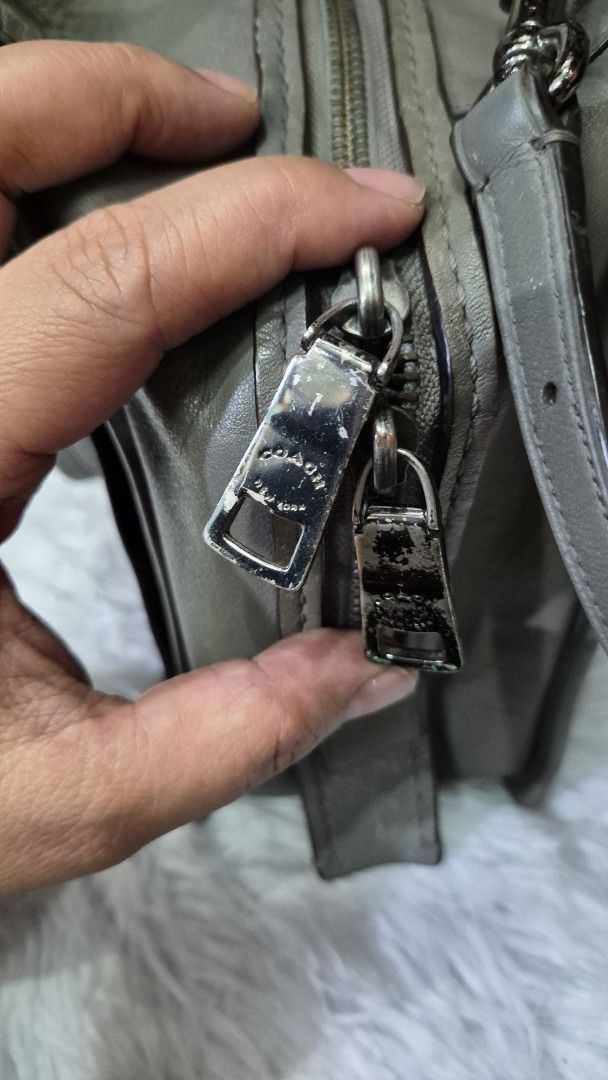 Coach Grey Leather Crossbody Shoulder Bag (Category: Looking For) located in Baguio. Submitted by jhaz_bags (Listing ID 1470680835, Image 3). Description: - Authentic Coach leather handbag in chic grey - Dual top handles and adjustable shoulder strap for versatile wear - Front exterior pocket with elegant gold-tone hardware - Secure dual zipper top closure with branded metal pull tabs - Signature Coach hangtag included - Fully lined interior - Co