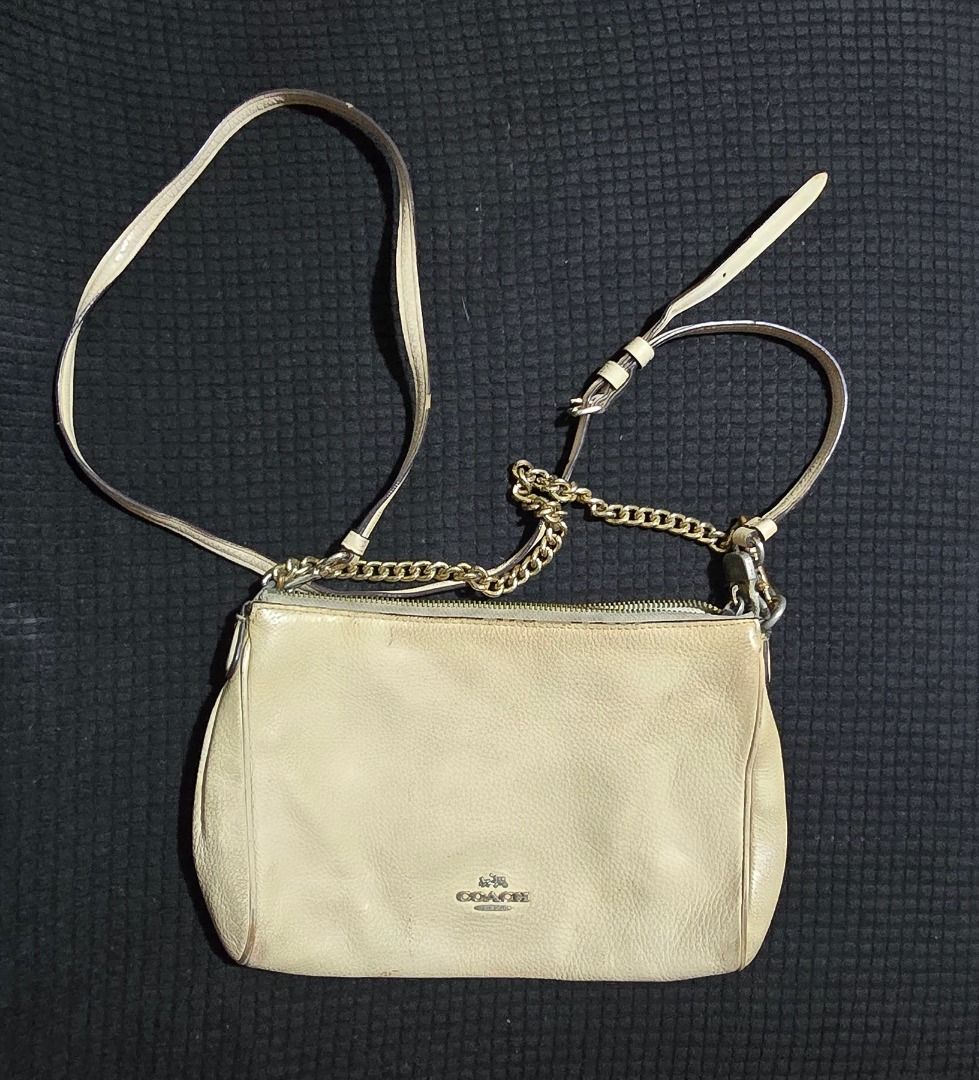 Coach Leather Crossbody Bag - Negotiable!!! (Category: Cross-body Bags) located in Manila. Submitted by axelyuna.27 (Listing ID 1470580355, Image 1). Description: Authentic Coach cream leather crossbody bag with gold hardware and chain strap details. Features a top zip closure, fabric lining, and an interior slip pocket. Has visible exterior scuffs and interior discoloration, but still makes a great everyday casual bag!.
