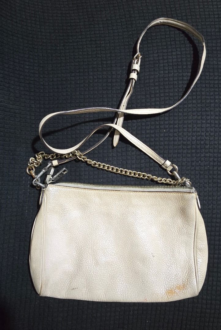 Coach Leather Crossbody Bag - Negotiable!!! (Category: Cross-body Bags) located in Manila. Submitted by axelyuna.27 (Listing ID 1470580355, Image 2). Description: Authentic Coach cream leather crossbody bag with gold hardware and chain strap details. Features a top zip closure, fabric lining, and an interior slip pocket. Has visible exterior scuffs and interior discoloration, but still makes a great everyday casual bag!.