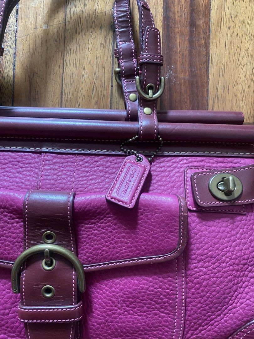 Coach Leather Handbag Pink Burgundy (Category: Luxury Bags & Wallets) located in Manila. Submitted by anthony1723 (Listing ID 1470697285, Image 2). Description: - Brand: Coach - Color: Pink and Burgundy - Material: Genuine leather with antique brass hardware - Exterior: Front pocket with buckle closure and metal turnlocks, double leather handles, and hanging tag - Interior: Pink monogram fabric lining with secure zipper closure - Authenticity: In