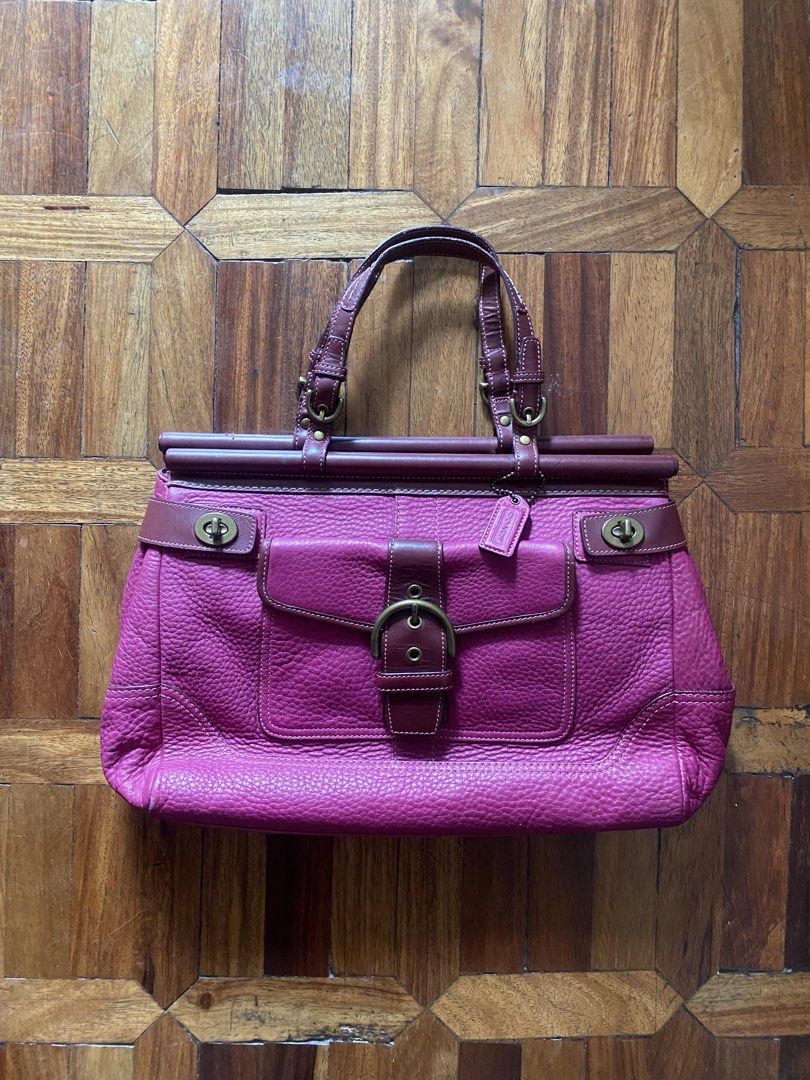Coach Leather Handbag Pink Burgundy (Category: Luxury Bags & Wallets) located in Manila. Submitted by anthony1723 (Listing ID 1470697285, Image 1). Description: - Brand: Coach - Color: Pink and Burgundy - Material: Genuine leather with antique brass hardware - Exterior: Front pocket with buckle closure and metal turnlocks, double leather handles, and hanging tag - Interior: Pink monogram fabric lining with secure zipper closure - Authenticity: In