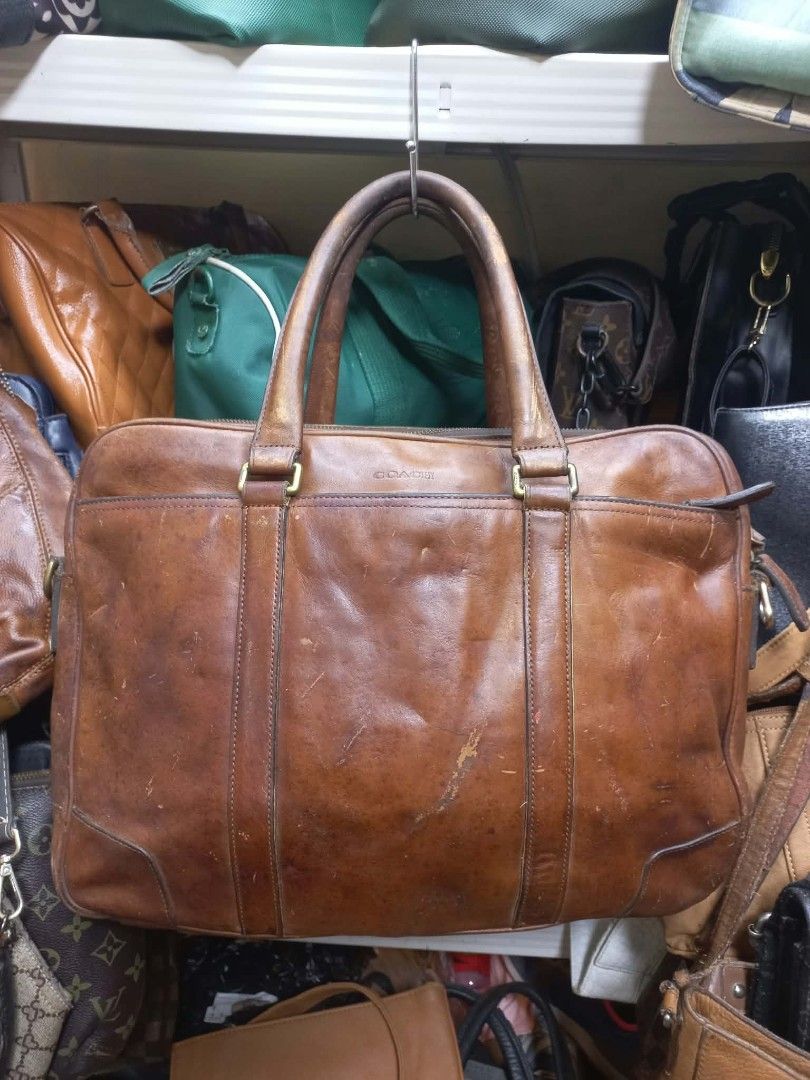 Coach Leather Laptop Briefcase Brown (Category: Briefcases) located in Quezon City. Submitted by dei03_diz (Listing ID 1470632336, Image 2). Description: - Authentic Coach leather briefcase in rich brown - Dual compartments with smooth zip closures and front slip pocket with debossed logo - Interior includes fabric lining, zip pocket, and creed patch (Serial: C1369-70777) - Sturdy top handles for easy carrying - Heavy scuffs, scratches, and authe