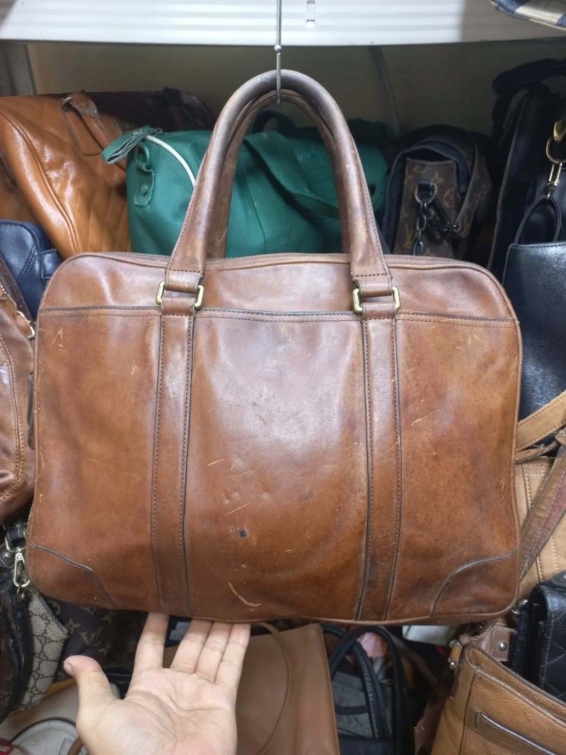 Coach Leather Laptop Briefcase Brown (Category: Briefcases) located in Quezon City. Submitted by dei03_diz (Listing ID 1470632336, Image 1). Description: - Authentic Coach leather briefcase in rich brown - Dual compartments with smooth zip closures and front slip pocket with debossed logo - Interior includes fabric lining, zip pocket, and creed patch (Serial: C1369-70777) - Sturdy top handles for easy carrying - Heavy scuffs, scratches, and authe