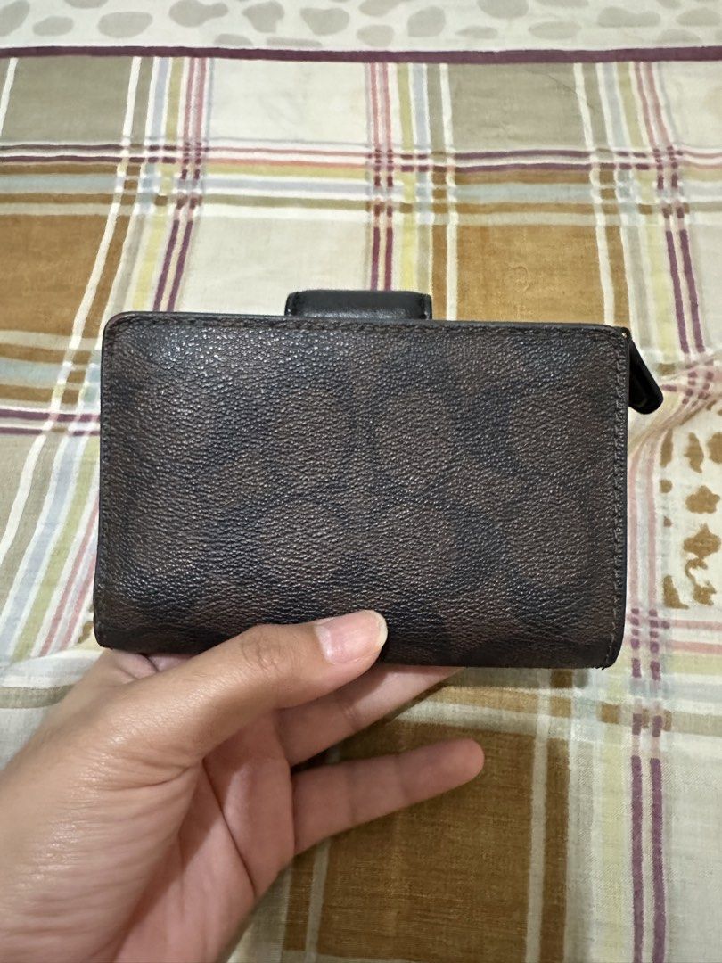 Coach Medium Corner Zip Signature Wallet (Category: Luxury Bags & Wallets) located in Bugallon. Submitted by lavenderlane (Listing ID 1470628698, Image 2). Description: - Brand: Coach - Material: Brown signature coated canvas with dark interior lining - Closure: Snap closure with gold-tone hardware and front embossed logo - Compartments: Multiple card slots, ID window, and full-length bill compartment - Coin Pocket: Convenient zipped coin pocket 