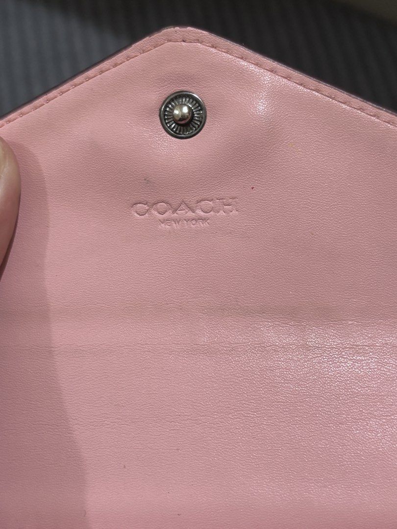 Coach Pink Heart Print Small Wallet (Category: Wallets & Card holders) located in Pasig City. Submitted by xandraaamia (Listing ID 1470675164, Image 2). Description: - Authentic Coach pink leather wallet - Charming all-over heart pattern design - Secure envelope flap closure with snap button - Subtle Coach New York front logo stamp - Premium interior leather lining - Compact size, ideal for daily use and small bags.
