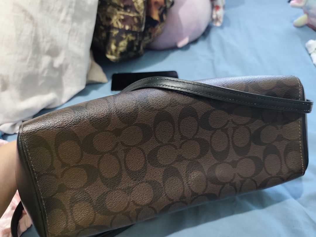 Coach Signature Brown Monogram Leather Handbag (Category: Luxury Bags & Wallets) located in Subic. Submitted by ferrero1982 (Listing ID 1470633141, Image 3). Description: - Authentic Coach shoulder bag in dark brown/black monogram & leather - Elegant gold-tone hardware and front logo lettering - Structured design with secure multiple compartments and top zip closure - Dual black leather top handles for comfortable wear - Includes signature matchi