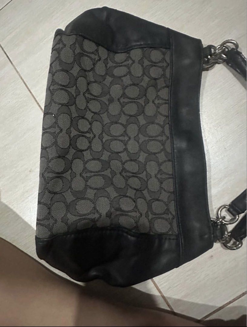 Coach Signature C Black Shoulder Bag (Category: Luxury Bags & Wallets) located in Manila. Submitted by zayzay08 (Listing ID 1470728435, Image 2). Description: - Brand: Coach - Material: Signature monogram fabric and leather - Color: Classic Black with Silver hardware - Straps: Double strap design with chic chain ring links - Closure: Secure zip-top plus magnetic snap closure - Interior: Includes a zippered pocket, slip compartments, and official 