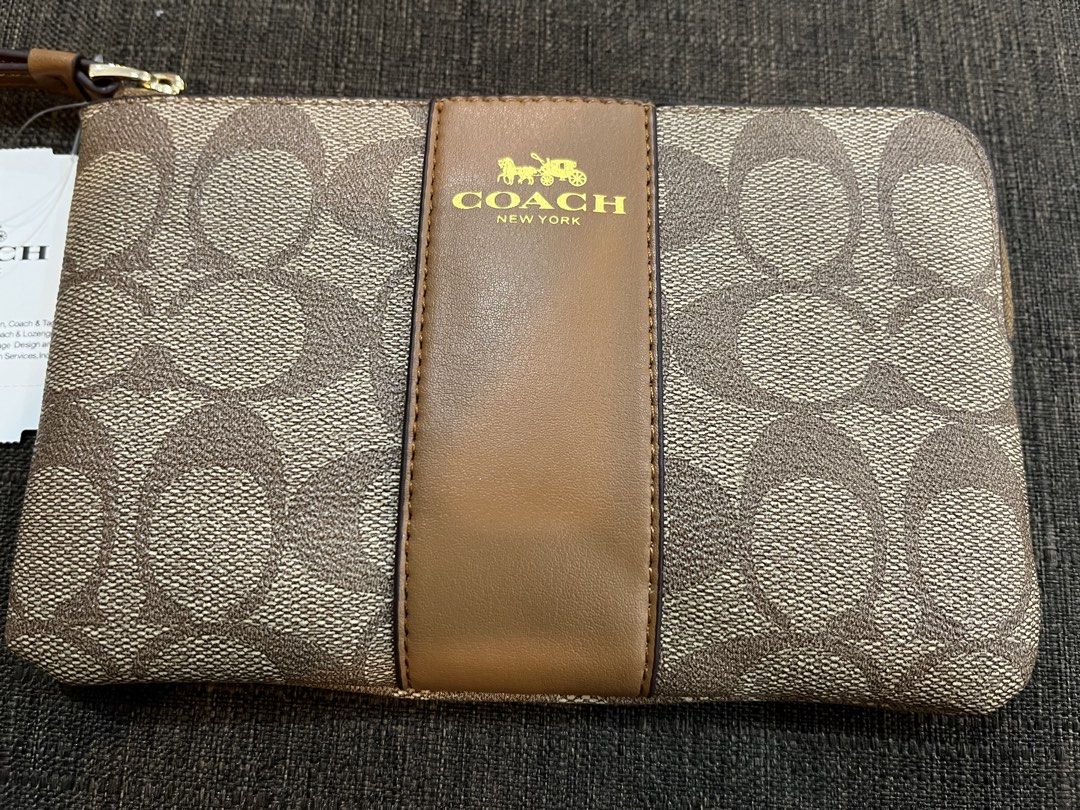 Coach Signature C Stripe Wristlet (Bundle) (Category: Luxury Bags & Wallets) located in Baguio. Submitted by elcie.08 (Listing ID 1470628076, Image 3). Description: - Brand new with tags attached - Coach signature C canvas with stylish center stripe - Secure zip-top closure with a convenient wrist strap - Interior fabric lining complete with built-in credit card slots - Compact and versatile for everyday use or gifting - ₱ 2,000 for both.