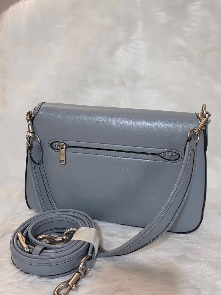 Coach Tabby Shoulder Bag Grey (Category: Luxury Bags & Wallets) located in Manila. Submitted by rachael_23 (Listing ID 1470622606, Image 3). Description: - Brand: Coach - Color: Light Grey - Material: Premium leather with silver-tone hardware - Closure: Signature C push-button front flap - Straps: Includes short shoulder strap and long adjustable crossbody strap - Pockets: Convenient exterior back zipper pocket and clean interior organization poc