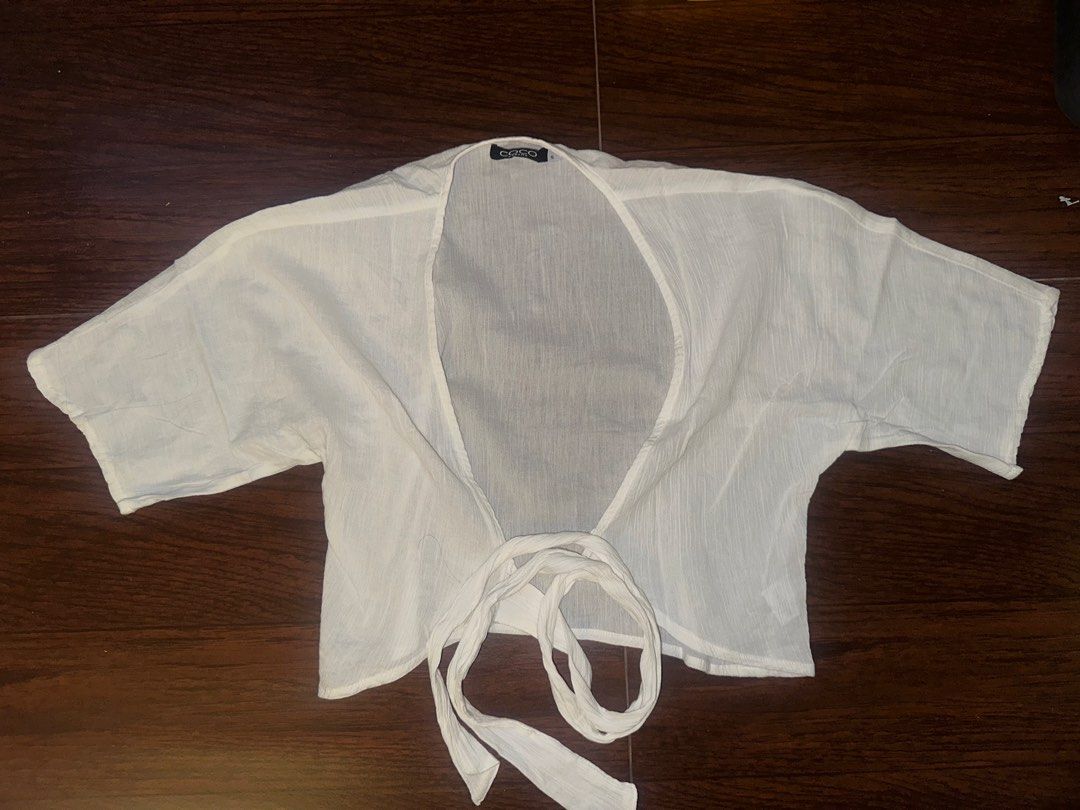 Coco Cabana White Tie-Front Short Sleeve Blouse Size S (Category: Blouses) located in Antipolo. Submitted by yhbc08 (Listing ID 1470610348, Image 1). Description: RFS: declutter✨ ✅Brand: Coco Cabana ✅Size: S ✅Color: White (Neutral) ✅Material: Lightweight gauze ✅Features: Short sleeves, open neckline, wrap-around waist tie ✅Perfect for: Swimwear cover-up or styling with high-waisted shorts.