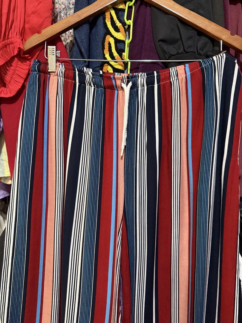 Urban Coco Colorful Stripes Jogger Pants (Category: Other Bottoms) located in Antipolo. Submitted by harlowwillow (Listing ID 1470743305, Image 3). Description: NO TO LOW BALLERS XL on tag W 16-21” L 43” Soft flowy material - Multi-color striped pants with a trendy vertical pattern (Red, navy blue, peach, and white) - Comfortable elastic waistband with an adjustable white drawstring tie - Cuffed ankles with elastic hem for a snug fit - Lightweigh