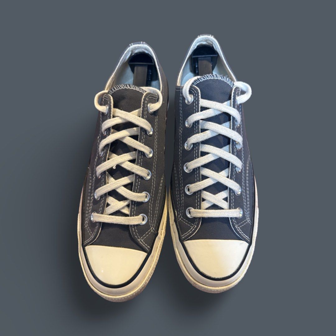 Converse Chuck 70 Low Dark Grey Sneakers (Category: Sneakers) located in Quezon City. Submitted by chey.mayuga (Listing ID 1470654631, Image 2). Description: - Model: Converse Chuck 70 Low Top - Color: Dark Grey canvas with off-white sole and black foxing stripe - Hardware: Silver metal eyelets with white laces - Features: Classic design, comfortable fit, and sturdy sole - Style: Versatile casual daily shoes.