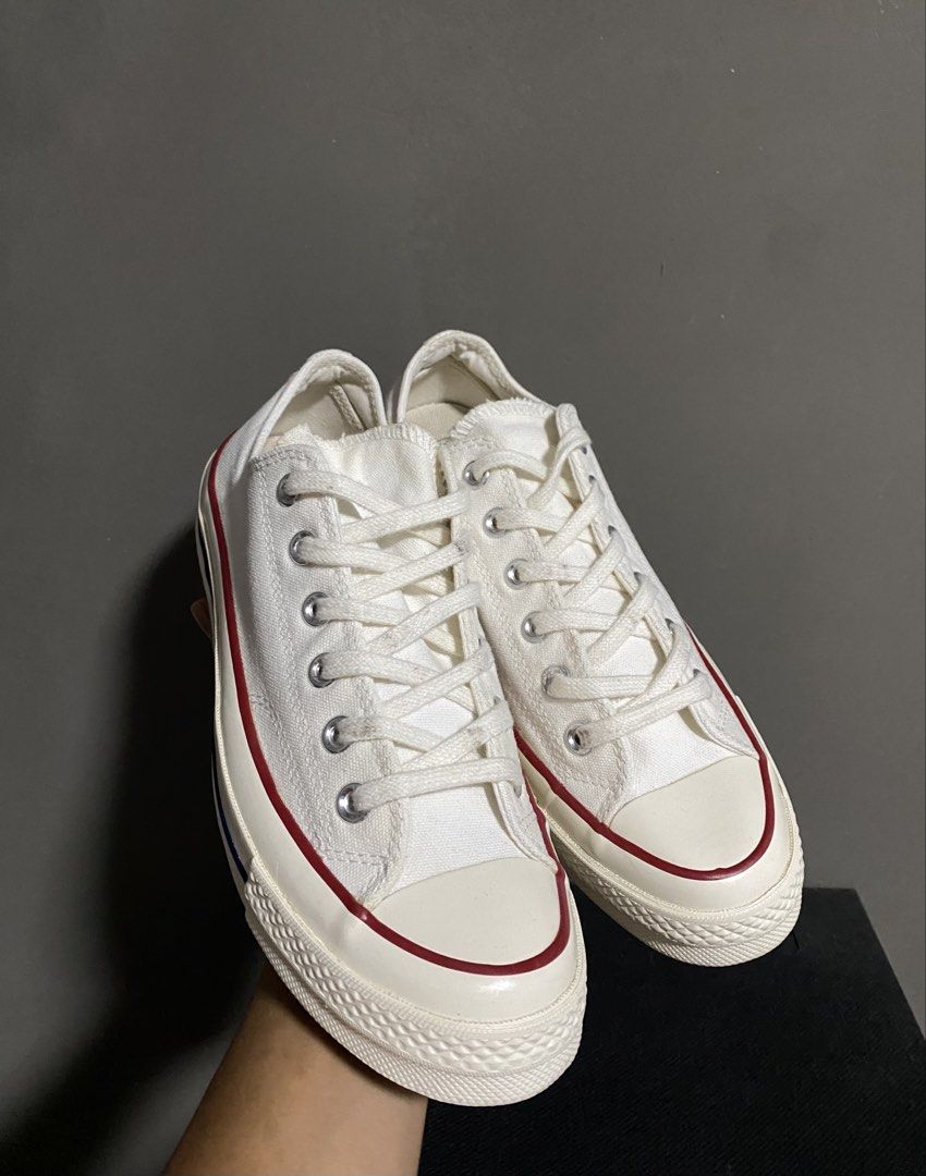 Converse Chuck 70 Low Top White Canvas Sneakers (Category: Sneakers) located in Manila. Submitted by smart_archives2000 (Listing ID 1470612942, Image 2). Description: Converse Chuck 70 low top sneakers in classic white canvas. Contrast red and blue pinstripe detailing along the midsole. Vintage style license plate logo on the heel. Silver eyelets and chunky rubber toe cap. Size is US Men 6.5 / Women 8.5. Clean condition all around..