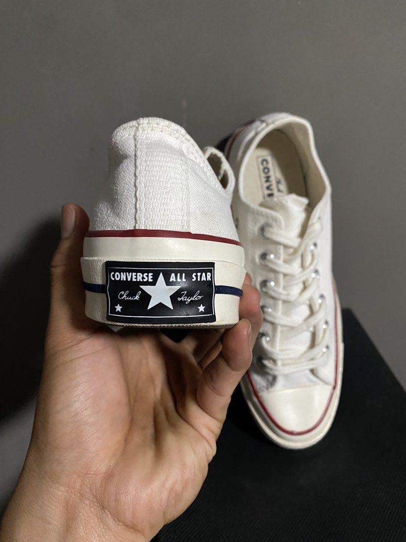 Converse Chuck 70 Low Top White Canvas Sneakers (Category: Sneakers) located in Manila. Submitted by smart_archives2000 (Listing ID 1470612942, Image 3). Description: Converse Chuck 70 low top sneakers in classic white canvas. Contrast red and blue pinstripe detailing along the midsole. Vintage style license plate logo on the heel. Silver eyelets and chunky rubber toe cap. Size is US Men 6.5 / Women 8.5. Clean condition all around..