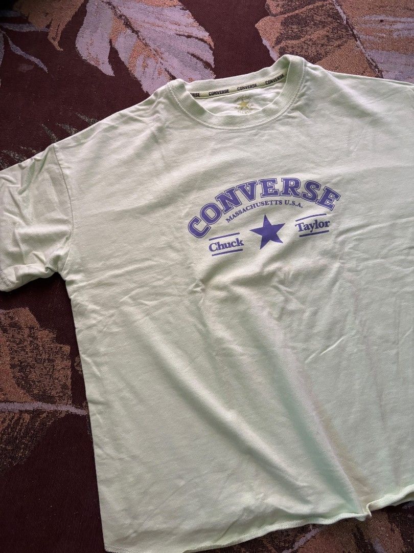 Converse Chuck Taylor Light Green Medium (Category: Tshirts & Polo Shirts ) located in Quezon City. Submitted by giveitalife (Listing ID 1470716146, Image 1). Description: - Brand: Converse Chuck Taylor - Color: Light green with purple retro chest print (Massachusetts U.S.A. & star graphic) - Size: Medium (printed on inside neck tag) - Fit: Relaxed fit with short sleeves - Details: Ribbed crew neck featuring branded taping inside the collar - Con
