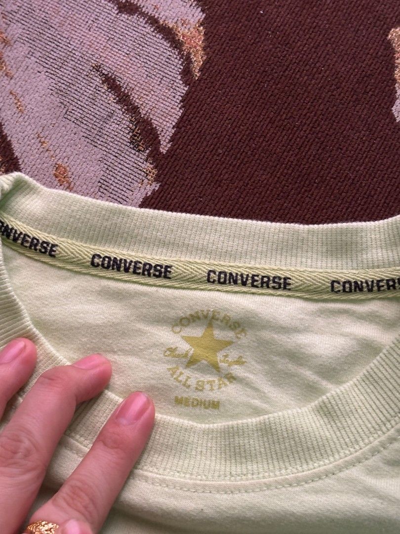 Converse Chuck Taylor Light Green Medium (Category: Tshirts & Polo Shirts ) located in Quezon City. Submitted by giveitalife (Listing ID 1470716146, Image 2). Description: - Brand: Converse Chuck Taylor - Color: Light green with purple retro chest print (Massachusetts U.S.A. & star graphic) - Size: Medium (printed on inside neck tag) - Fit: Relaxed fit with short sleeves - Details: Ribbed crew neck featuring branded taping inside the collar - Con