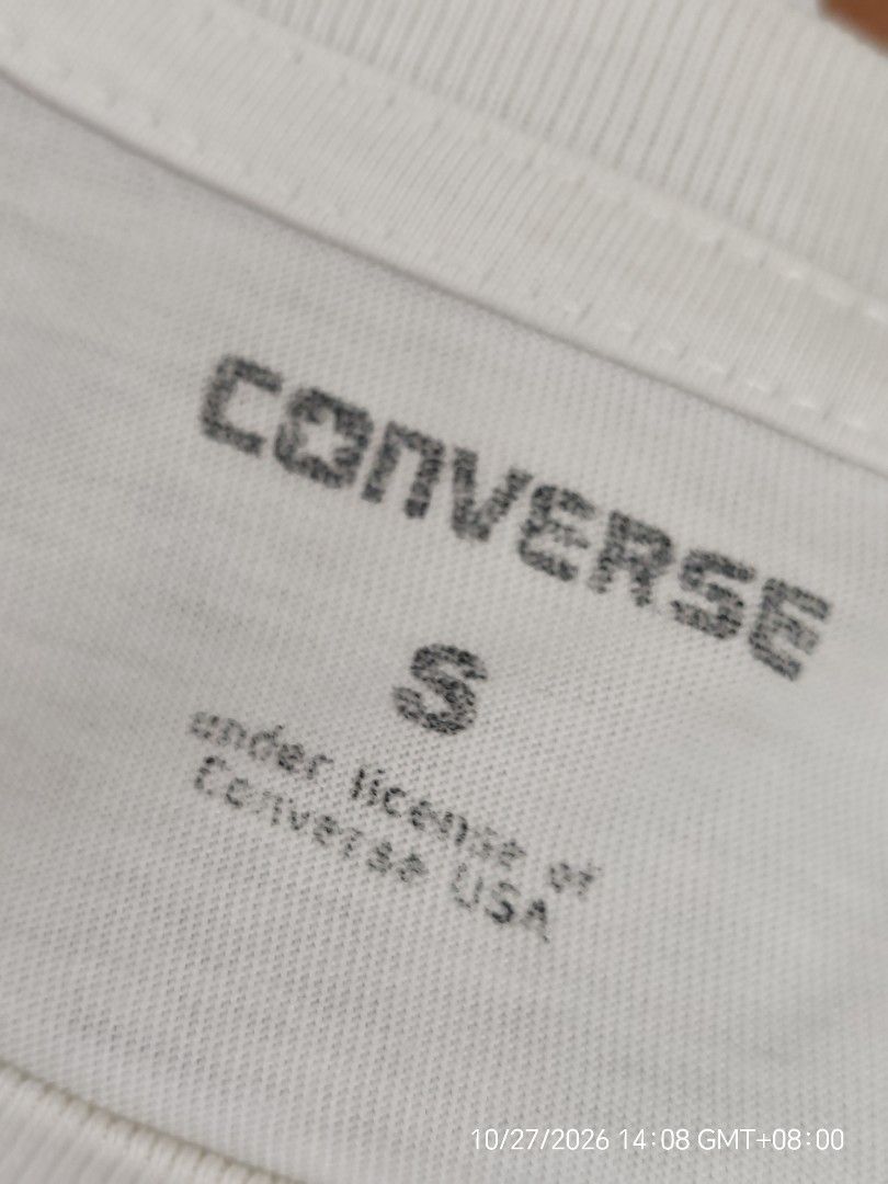 Converse Typography Graphic White T-Shirt Size S (Category: Shirts) located in Antipolo. Submitted by purpleclover11 (Listing ID 1470607072, Image 3). Description: - Brand: Converse (Under license of Converse USA) - Style: White graphic tee with all-over typography print - Size: Small (tag on inside collar) - Condition: Pre-owned - Flaw: One small yellowish stain near the right shoulder seam - Perfect casual piece for everyday streetwear looks -U