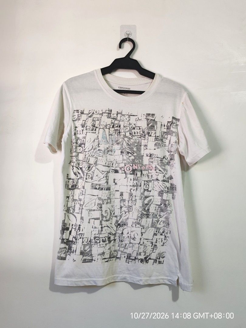 Converse Typography Graphic White T-Shirt Size S (Category: Shirts) located in Antipolo. Submitted by purpleclover11 (Listing ID 1470607072, Image 1). Description: - Brand: Converse (Under license of Converse USA) - Style: White graphic tee with all-over typography print - Size: Small (tag on inside collar) - Condition: Pre-owned - Flaw: One small yellowish stain near the right shoulder seam - Perfect casual piece for everyday streetwear looks -U