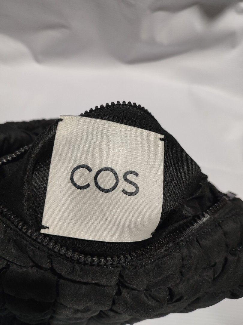 COS Quilted Mini Bag Black (Category: Luxury Bags & Wallets) located in Puerto Princesa. Submitted by thriftedsoulsy2k (Listing ID 1470675691, Image 2). Description: - Brand: COS - Style: Quilted mini bag in classic black - Design: Signature puffy quilted texture with sleek minimalist look - Features: Top zip closure and comfortable padded handle - Capacity: Spacious enough for your daily essentials - Condition: Interior label intact - Origin: Ma