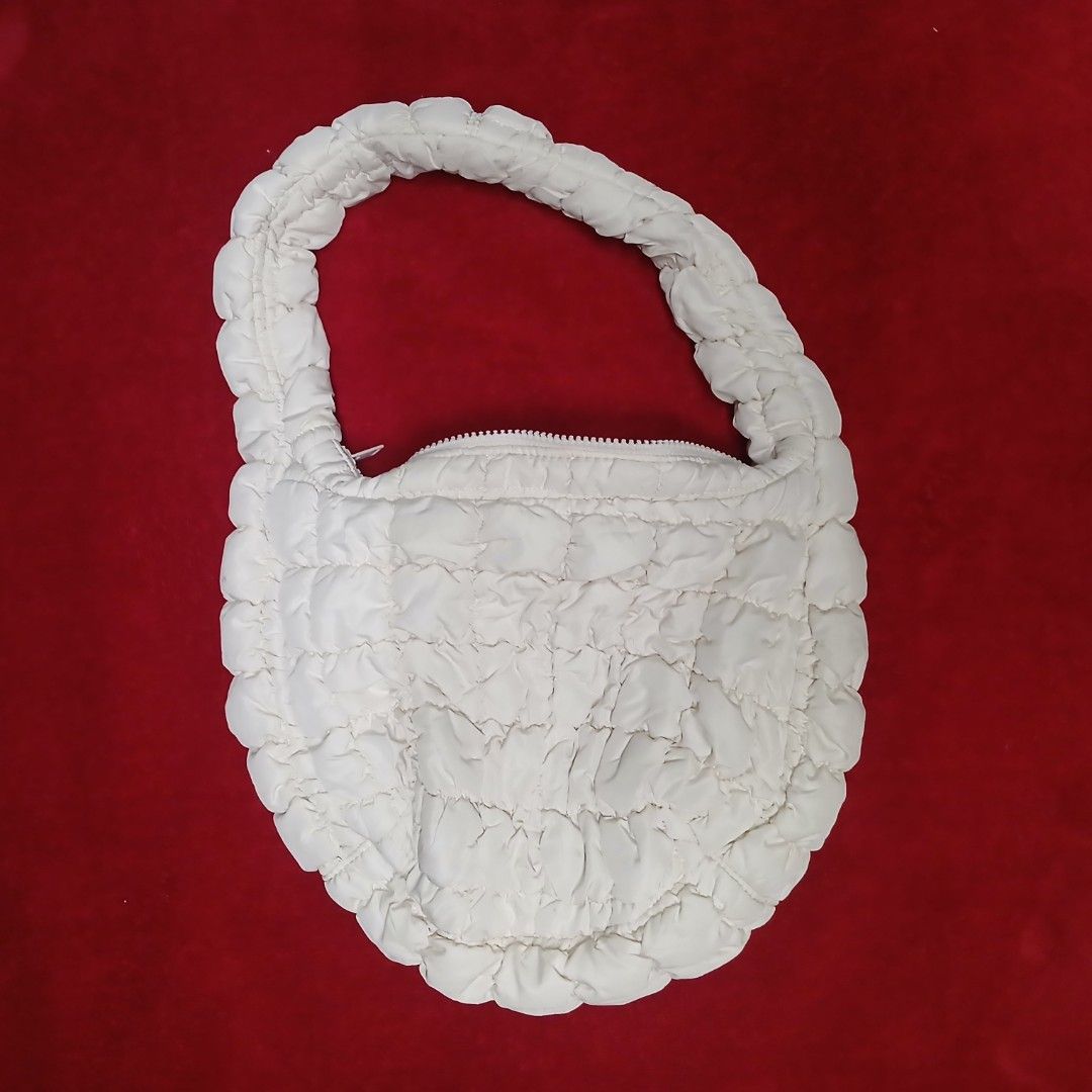 COS Quilted Mini Shoulder Bag (Off-White) (Category: Shoulder Bags) located in Cagayan de Oro. Submitted by susanthrifts (Listing ID 1470559767, Image 1). Description: ​COS ​Color: Off-White / Cream ​Style: Quilted / Padded Crescent Shoulder Bag ​Features: Top zip closure with SAB zipper, soft curved handle, fully lined interior with COS brand label. ​Condition: Excellent pre-owned condition. Clean body.