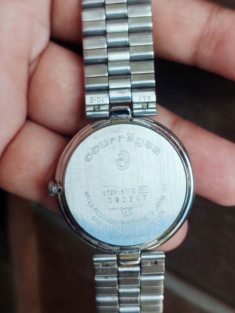 Courrèges Two-Tone Quartz Watch (Category: Women's Watches) located in Batangas. Submitted by vintageanddainty (Listing ID 1470584788, Image 3). Description: Courrèges women's wristwatch in silver and gold tone. White textured grid dial with gold numbers at 12, 3, 6, and 9. Link bracelet with clasp closure featuring the Courrèges logo. Japanese quartz movement. Shows light surface scratches from normal wear on the bezel and bracelet. Classic vint