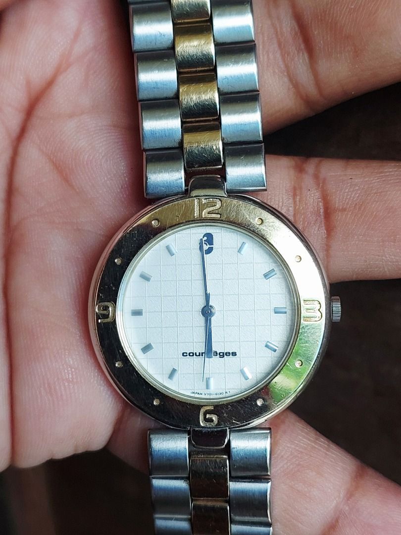 Courrèges Two-Tone Quartz Watch (Category: Women's Watches) located in Batangas. Submitted by vintageanddainty (Listing ID 1470584788, Image 2). Description: Courrèges women's wristwatch in silver and gold tone. White textured grid dial with gold numbers at 12, 3, 6, and 9. Link bracelet with clasp closure featuring the Courrèges logo. Japanese quartz movement. Shows light surface scratches from normal wear on the bezel and bracelet. Classic vint