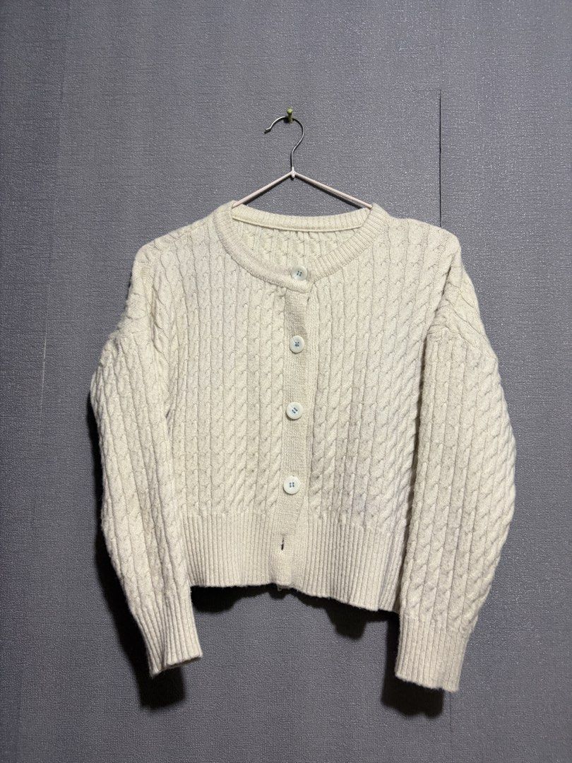 Cream Cable Knit Button-Up Cardigan (Category: Coats, Jackets and Outerwear) located in Manila. Submitted by wildriver.e8b64e (Listing ID 1470707094, Image 2). Description: - Color: Cozy cream - Material: Soft knit with textured cable pattern - Design: Round neckline, front button closure with white marbled buttons - Fit: Ribbed cuffs and hem to hold its shape - Style: Great layering piece for cooler weather, easy to match with jeans or skirts.