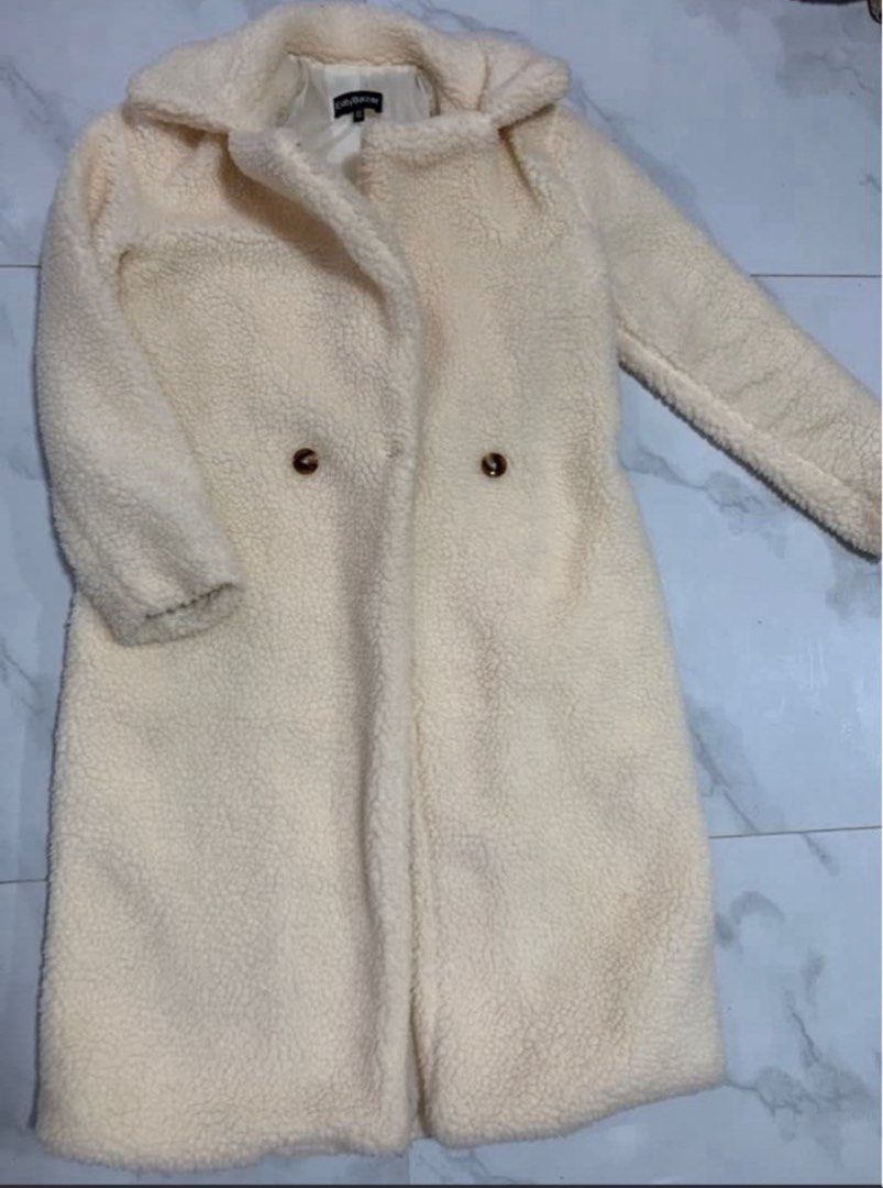 Cream Teddy Bear Long Coat (Category: Coats, Jackets and Outerwear) located in Manila. Submitted by decluterthings888 (Listing ID 1470560125, Image 2). Description: - Color: Cream - Style: Long teddy bear coat with lapel collar - Closure: Tortoiseshell double-breasted buttons - Interior: Fully lined for extra warmth - Material: Soft fleece-like texture - Condition: Great winter outerwear piece to layer over any outfit.