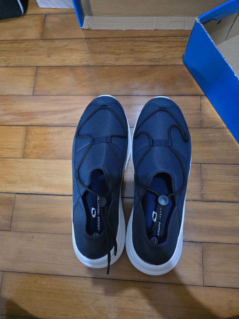 Cross Trekkers Navy Blue Slip-On (Category: Sneakers) located in Manila. Submitted by general_sellerr (Listing ID 1470620111, Image 2). Description: - Brand: Cross Trekkers - Color: Navy blue with white chunky soles - Closure: Black bungee lace system - Material: Clean textile upper - Ideal for: Comfortable everyday walking and casual wear.
