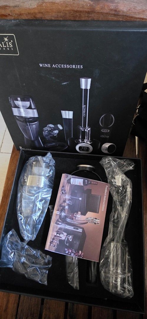 Crysalis Stemware Wine Accessories 8-Piece Set (Category: Dinnerware & Cutlery) located in Santa Maria. Submitted by ellahqy28 (Listing ID 1470572468, Image 2). Description: - Brand new, never used Crysalis Stemware wine accessories set - Comes in the original presentation box with instruction booklet - Includes 8 pieces total, all still sealed in original plastic packaging - Box lid features all included items: thermometer ring, aerator, pourer,