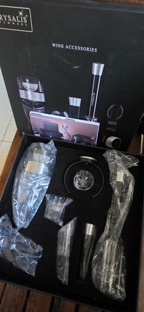 Crysalis Stemware Wine Accessories 8-Piece Set (Category: Dinnerware & Cutlery) located in Santa Maria. Submitted by ellahqy28 (Listing ID 1470572468, Image 3). Description: - Brand new, never used Crysalis Stemware wine accessories set - Comes in the original presentation box with instruction booklet - Includes 8 pieces total, all still sealed in original plastic packaging - Box lid features all included items: thermometer ring, aerator, pourer,