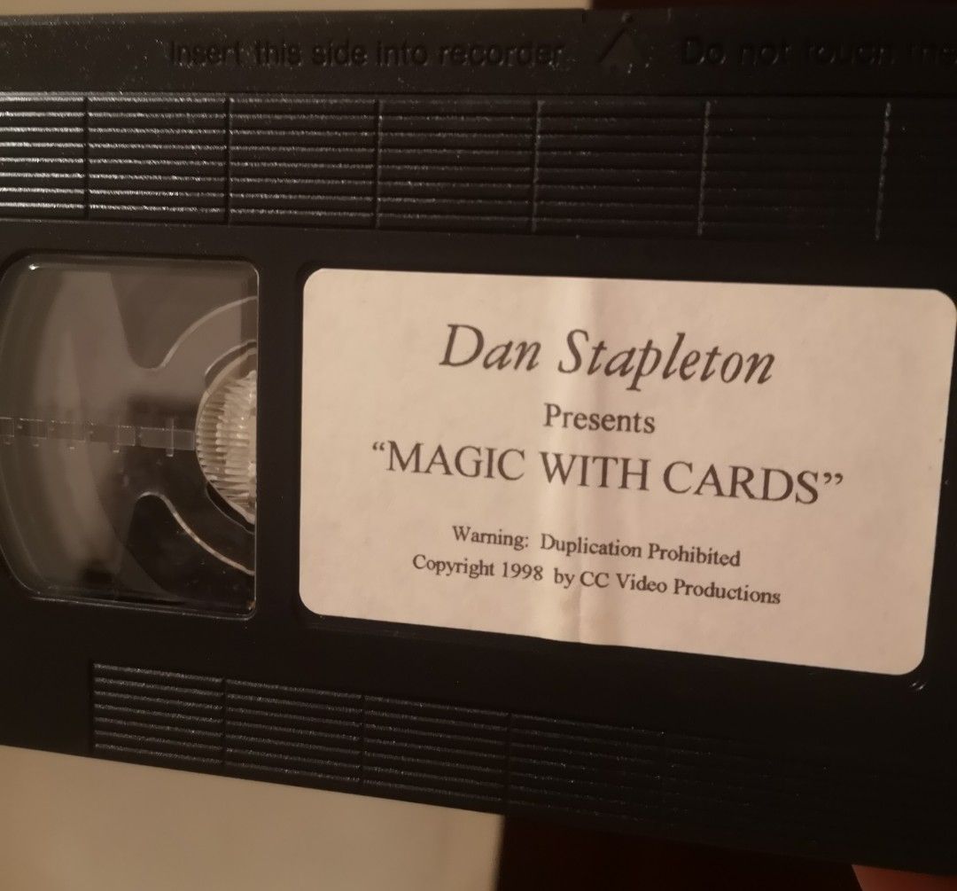 Dan Stapleton Presents Magic With Cards VHS Tape (Category: Vintage Collectibles) located in Quezon City. Submitted by dhanie.barican (Listing ID 1470717998, Image 2). Description: - Title: Magic With Cards VHS hosted by Dan Stapleton - Content: Learn baffling yet easy-to-perform card tricks using an ordinary deck - Release Year: 1998 by CC Video Productions - Condition/Includes: Original cardboard slipcase and tape with custom label - Ideal For: