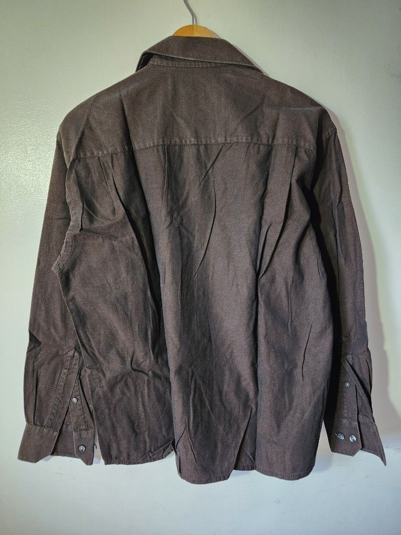 Dark Brown Long Sleeve Button Down Shirt Men (Category: Longsleeves) located in Meycauayan. Submitted by MP_Shop (Listing ID 1470576012, Image 2). Description: - Color: Dark brown - Size: Medium - Material: 100% cotton (Made in Philippines) - Design: Textured fabric, classic collar, single chest pocket - Closure: Standard buttons on front and cuffs - Versatile staple perfect for casual wear or layering Size: 21.5W x 25L inches Excellent Condition