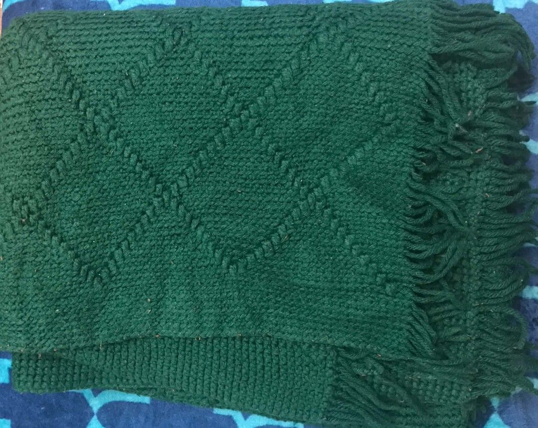 Dark green knitted throw blanket with fringe (Category: Bedding & Towels) located in Imus. Submitted by stop_shop7 (Listing ID 1470621655, Image 1). Description: - Color: Rich forest green - Design: Deep diamond knit pattern with textured borders and long fringe - Ideal for: Draping over sofas or armchairs to add a cozy touch - Need wash.