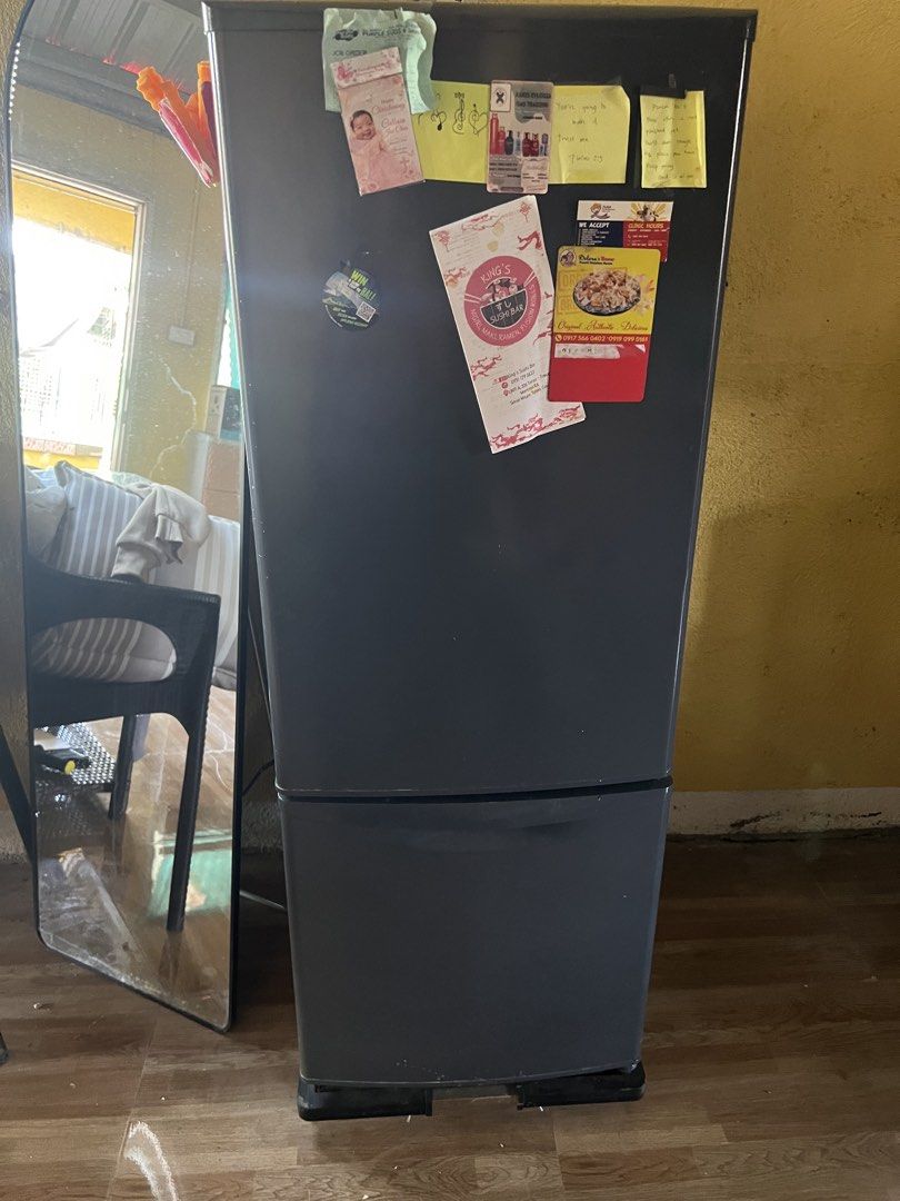 Dark Grey Bottom Freezer Refrigerator (Category: Refrigerators and Freezers) located in Manila. Submitted by lorrainera64392 (Listing ID 1470604565, Image 1). Description: - Color: Dark grey - Type: Two-door fridge with bottom freezer drawer - Condition: Clean interior, works perfectly, minor notes and magnets on the front door - Features: Adjustable glass shelves and door bins - Fit: Standard size, ideal for apartment kitchens.