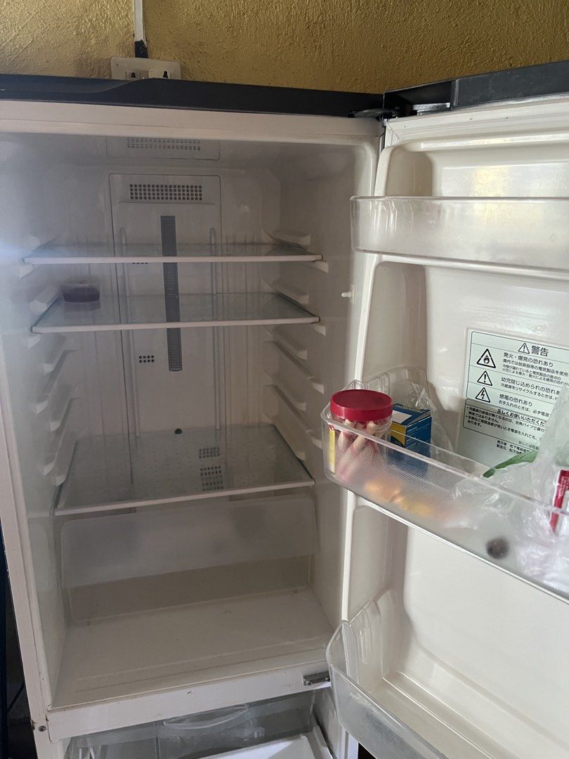 Dark Grey Bottom Freezer Refrigerator (Category: Refrigerators and Freezers) located in Manila. Submitted by lorrainera64392 (Listing ID 1470604565, Image 3). Description: - Color: Dark grey - Type: Two-door fridge with bottom freezer drawer - Condition: Clean interior, works perfectly, minor notes and magnets on the front door - Features: Adjustable glass shelves and door bins - Fit: Standard size, ideal for apartment kitchens.
