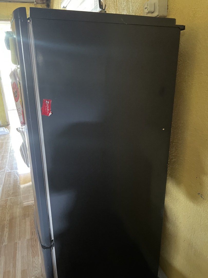 Dark Grey Bottom Freezer Refrigerator (Category: Refrigerators and Freezers) located in Manila. Submitted by lorrainera64392 (Listing ID 1470604565, Image 2). Description: - Color: Dark grey - Type: Two-door fridge with bottom freezer drawer - Condition: Clean interior, works perfectly, minor notes and magnets on the front door - Features: Adjustable glass shelves and door bins - Fit: Standard size, ideal for apartment kitchens.