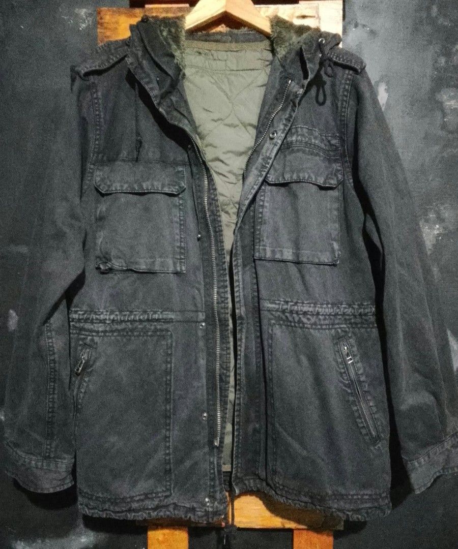 Dark Grey Hooded Utility Jacket with Quilted Lining (Category: Coats, Jackets and Outerwear) located in Manila. Submitted by fastdragon_62f8c6 (Listing ID 1470647783, Image 3). Description: - Color: Dark grey with olive green quilted lining - Material: Heavy canvas cotton outer layer - Closure: Secure zip and snap button front - Features: Multiple front pockets, drawstring hood and waist, and faux fur collar trim - Style: Rugged, warm, and ideal 