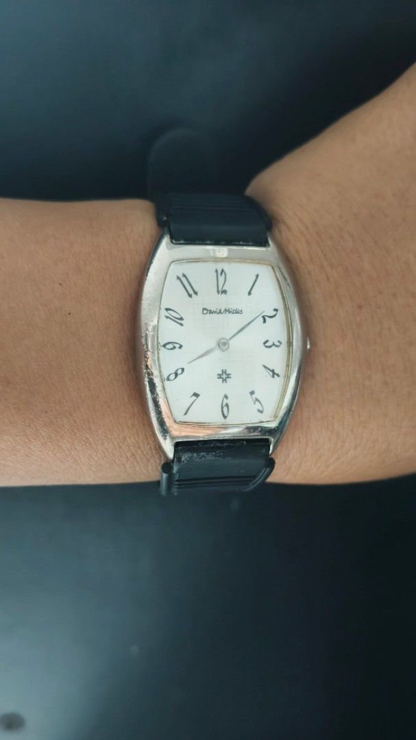 David Hicks Tonneau Watch with Black Rubber Strap (Category: Luxury Watches) located in Taguig. Submitted by mercyeugen28914 (Listing ID 1470678885, Image 2). Description: - Brand/Model: David Hicks Quartz Watch - Case: Silver-tone curved tonneau case with normal wear on the bezel - Dial: Clean white dial with classic black Arabic numerals and well-functioning hands - Movement: Reliable Japan movement - Strap: Black rubber strap with steel buckle