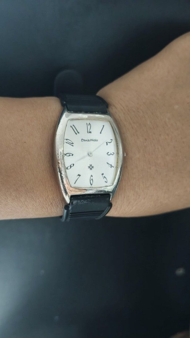 David Hicks Tonneau Watch with Black Rubber Strap (Category: Luxury Watches) located in Taguig. Submitted by mercyeugen28914 (Listing ID 1470678885, Image 3). Description: - Brand/Model: David Hicks Quartz Watch - Case: Silver-tone curved tonneau case with normal wear on the bezel - Dial: Clean white dial with classic black Arabic numerals and well-functioning hands - Movement: Reliable Japan movement - Strap: Black rubber strap with steel buckle