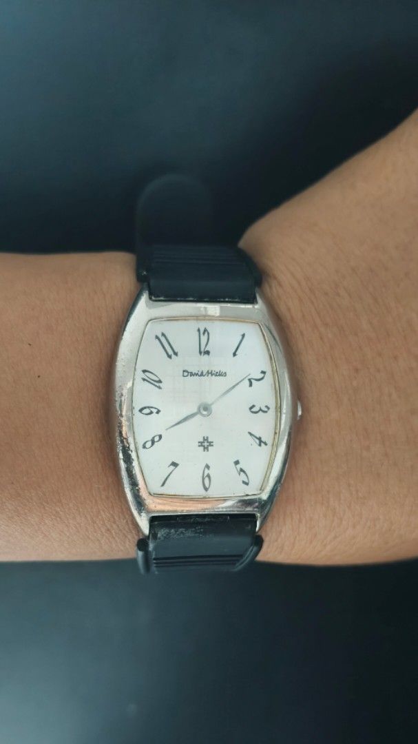 David Hicks Tonneau Watch with Black Rubber Strap (Category: Luxury Watches) located in Taguig. Submitted by mercyeugen28914 (Listing ID 1470678885, Image 1). Description: - Brand/Model: David Hicks Quartz Watch - Case: Silver-tone curved tonneau case with normal wear on the bezel - Dial: Clean white dial with classic black Arabic numerals and well-functioning hands - Movement: Reliable Japan movement - Strap: Black rubber strap with steel buckle