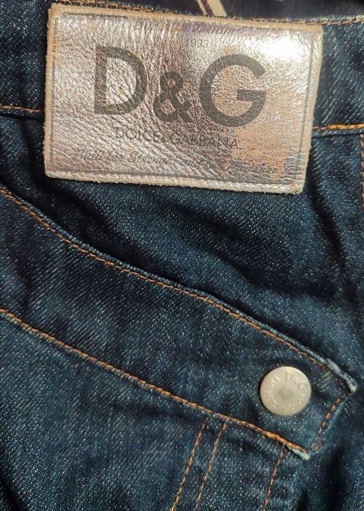 D&G Dolce & Gabbana Denim Skirt (Category: Skirts) located in Manila. Submitted by cosmictree_1321 (Listing ID 1470579049, Image 2). Description: - Brand: D&G Dolce & Gabbana - Style: Vintage Y2K asymmetric crossover denim skirt - Wash: Dark blue with contrast stitching and panel construction - Details: Branded metal buttons, rivets, and small coin pocket with woven logo label - Material: 100% cotton outer - Origin: Made in Italy - Condition: Exc