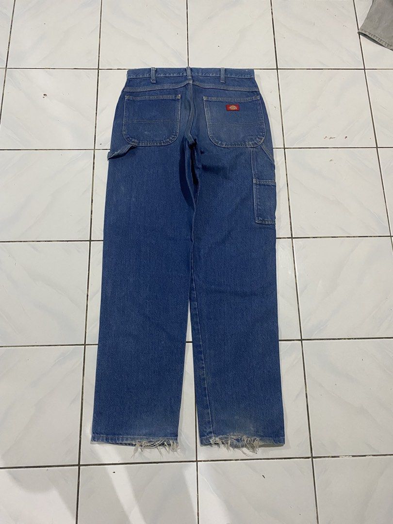 Dickies Blue Denim Carpenter Jeans (Category: Jeans) located in Cavite. Submitted by findsmore (Listing ID 1470742945, Image 1). Description: - Brand: Dickies - Color: Blue denim - Style: Classic utility carpenter jeans with straight leg fit - Features: Side tool pockets, hammer loop, button closure, and belt loops - Condition: Worn-in workwear look with natural fading, light front stains, and frayed ankle hems.