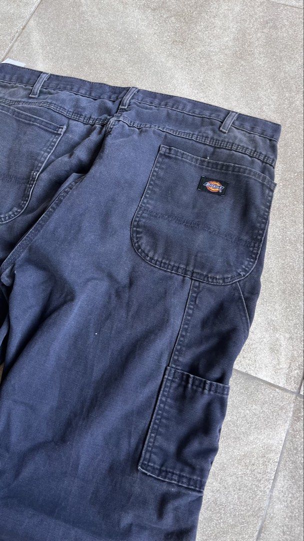 Dickies Dark Blue Carpenter Pants Workwear 38x30 (Category: Jeans) located in Cabuyao City. Submitted by bulandos (Listing ID 1470656248, Image 3). Description: - Brand: Dickies - Size: 38x30 - Color: Dark blue with a faded wash - Material: Heavy-duty canvas - Features: Side tool pockets, hammer loop, classic relaxed workwear fit - Condition: Heavy distressing and fraying at both cuffs, with authentic work stains throughout from everyday wear.