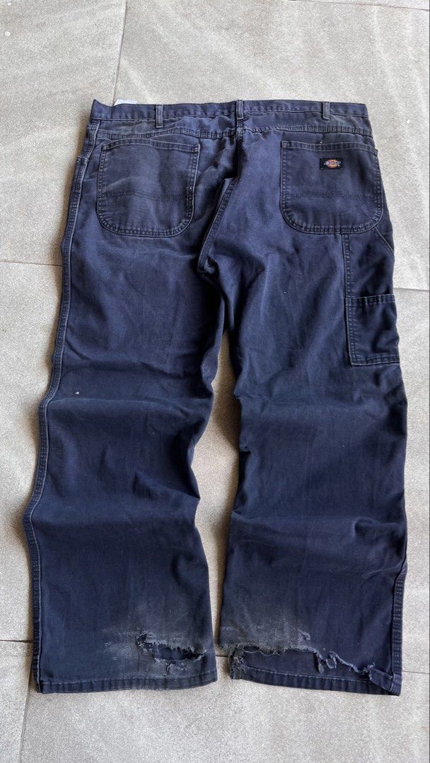 Dickies Dark Blue Carpenter Pants Workwear 38x30 (Category: Jeans) located in Cabuyao City. Submitted by bulandos (Listing ID 1470656248, Image 1). Description: - Brand: Dickies - Size: 38x30 - Color: Dark blue with a faded wash - Material: Heavy-duty canvas - Features: Side tool pockets, hammer loop, classic relaxed workwear fit - Condition: Heavy distressing and fraying at both cuffs, with authentic work stains throughout from everyday wear.