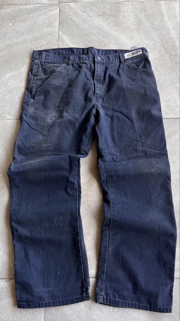 Dickies Dark Blue Carpenter Pants Workwear 38x30 (Category: Jeans) located in Cabuyao City. Submitted by bulandos (Listing ID 1470656248, Image 2). Description: - Brand: Dickies - Size: 38x30 - Color: Dark blue with a faded wash - Material: Heavy-duty canvas - Features: Side tool pockets, hammer loop, classic relaxed workwear fit - Condition: Heavy distressing and fraying at both cuffs, with authentic work stains throughout from everyday wear.