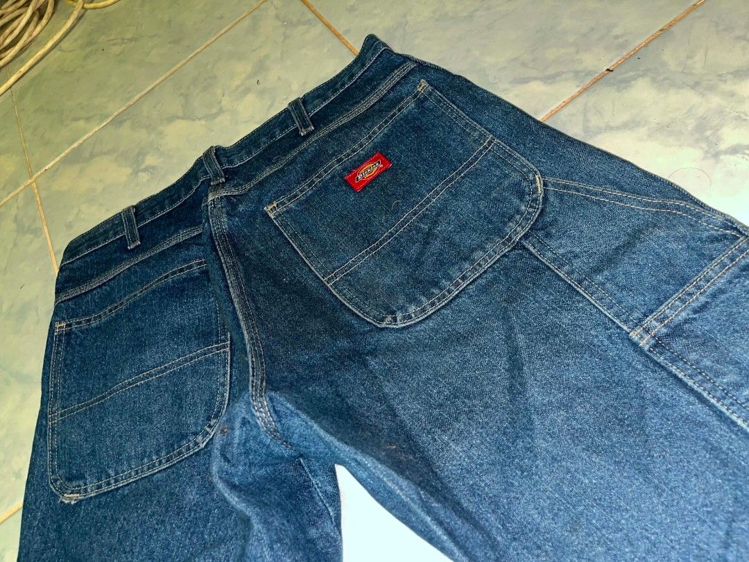Dickies Denim Jeans Work Pants Blue (Category: Jeans) located in Tuguegarao City. Submitted by ZeevLim (Listing ID 1470699972, Image 2). Description: - Brand: Dickies - Color/Wash: Classic blue, deep indigo - Fit: Regular fit, straight leg -cuttags/dir stain - Details: Metal button closure, signature red back pocket label - Condition: Has authentic dark wear marks on the knees from actual use.