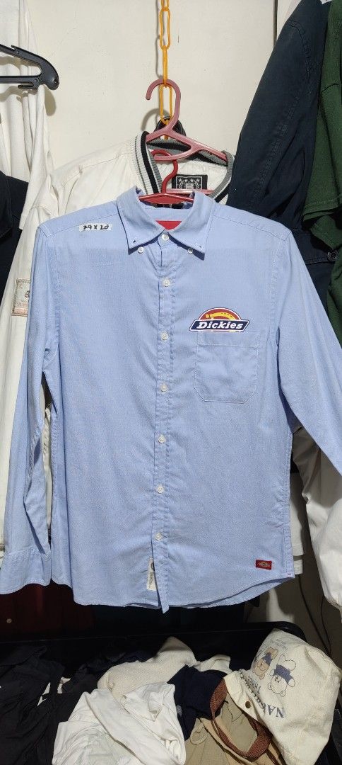 Dickies Light Blue Long Sleeve Button-Down Shirt (Category: Tshirts & Polo Shirts ) located in Bulacan. Submitted by adrian2325 (Listing ID 1470641846, Image 1). Description: - Brand: Dickies - Color: Light Blue - Style: Long-sleeve button-down shirt with classic collar - Material: 65% Cotton, 35% Polyester blend for comfort and durability - Details: Left chest pocket with iconic Dickies logo patch - Cuffs: Button cuffs on sleeves - Hem: Branded 