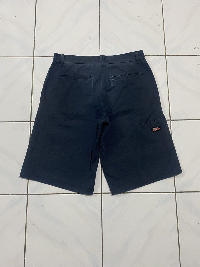 Dickies Navy Blue Work Shorts (Category: Shorts) located in Cavite. Submitted by findsmore (Listing ID 1470742774, Image 2). Description: - Brand: Dickies - Color: Navy Blue - Style: Classic work shorts with belt loops and standard pockets - Details: Signature Dickies logo patch on the back pocket - Condition: Durable fabric with noticeable staining and wear marks on the front - Best For: Everyday workwear, DIY projects, or casual utility wear.